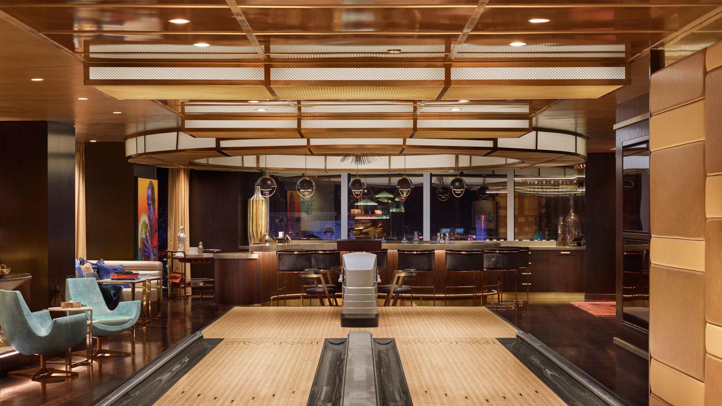 The step-up bowling alley has a linear bronze ceiling that cascades down the back wall.