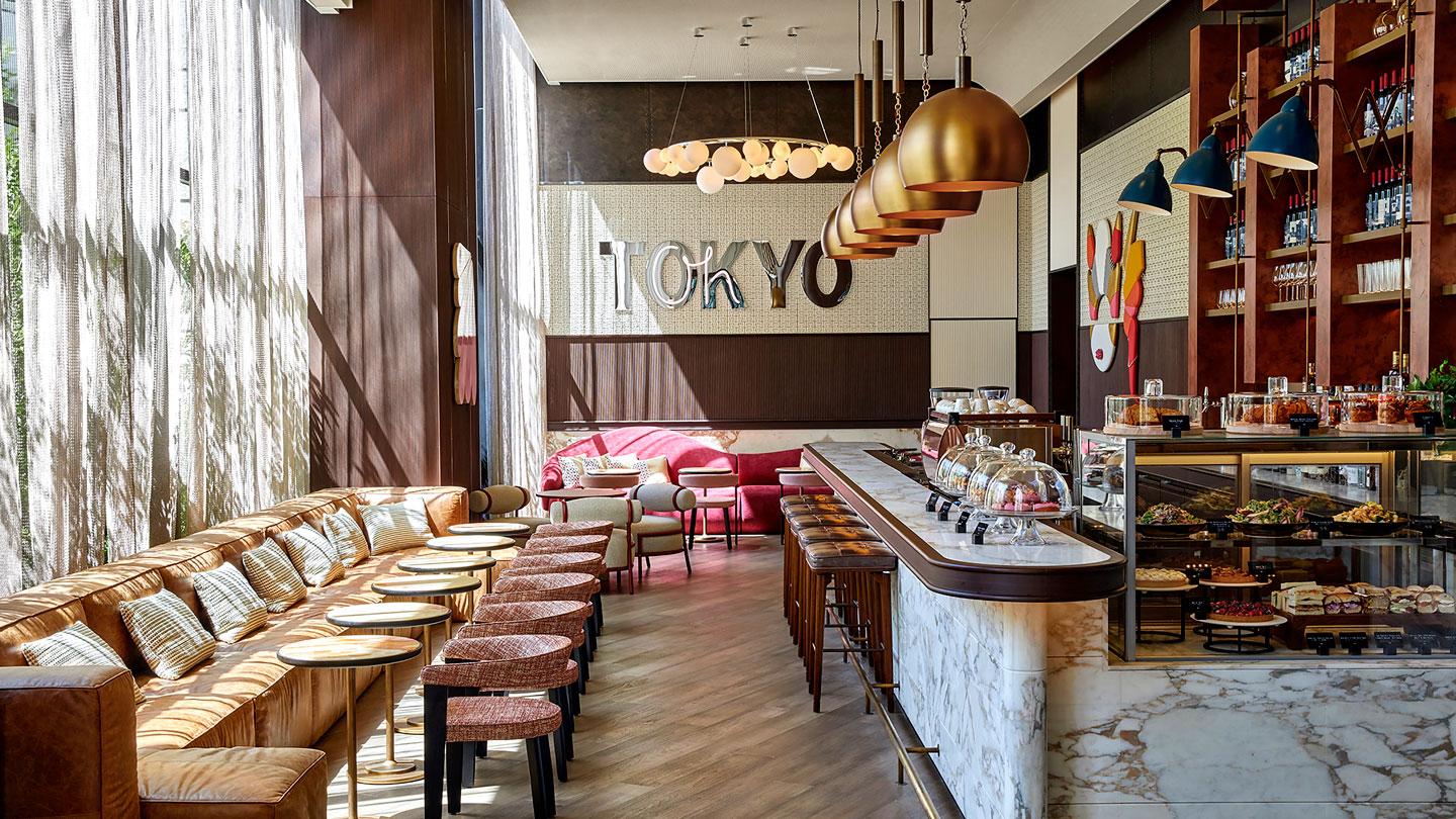 View of bar and seating at Kimpton Hotel Tokyo's cafe designed by Rockwell Group