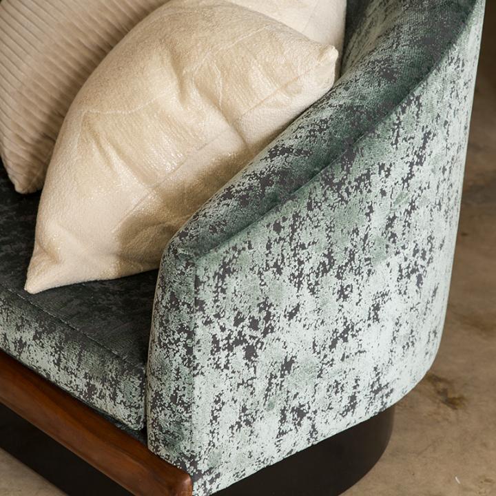 Detail of chair and pillows covered in fabric designed by David Rockwell in a living room