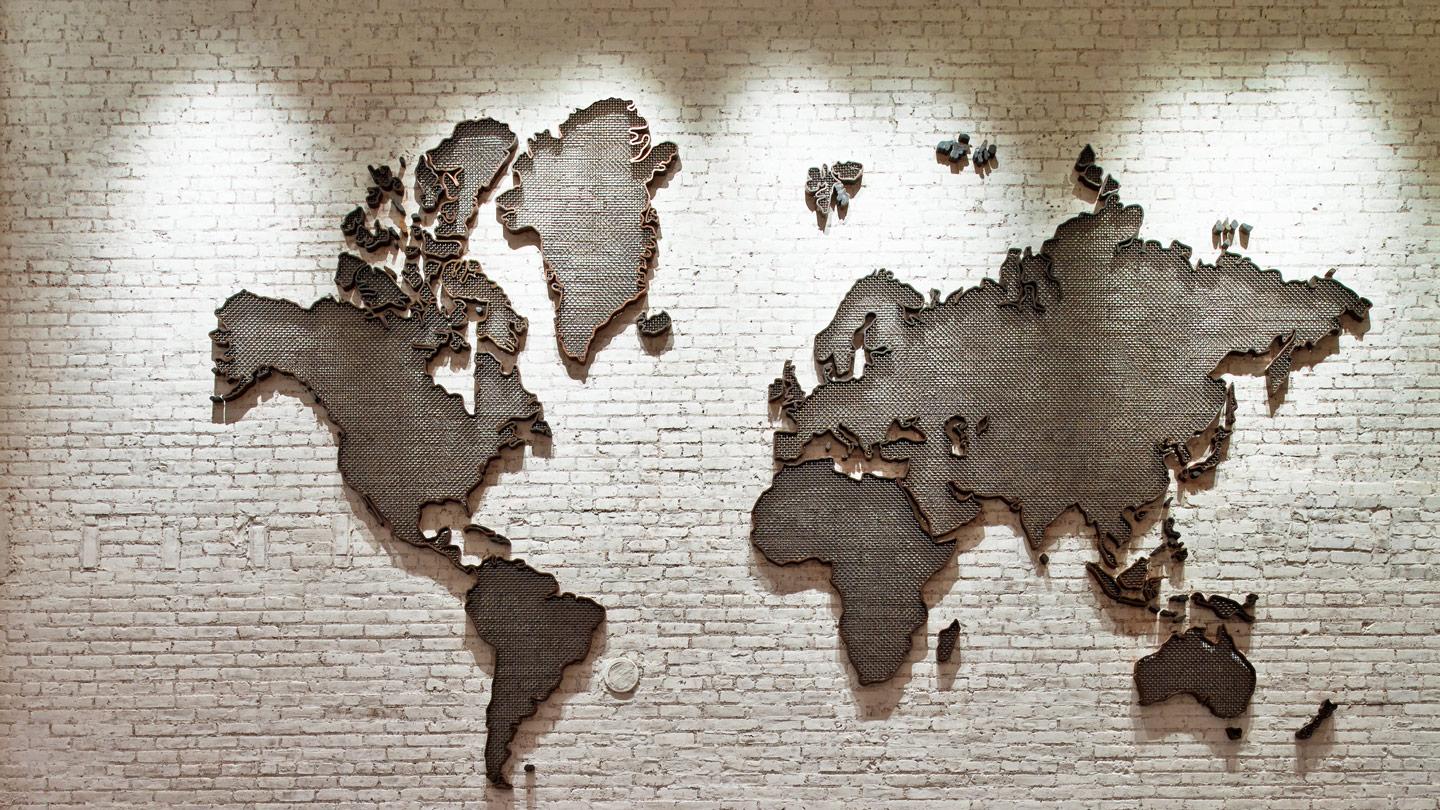 world map made of bronze on a wall