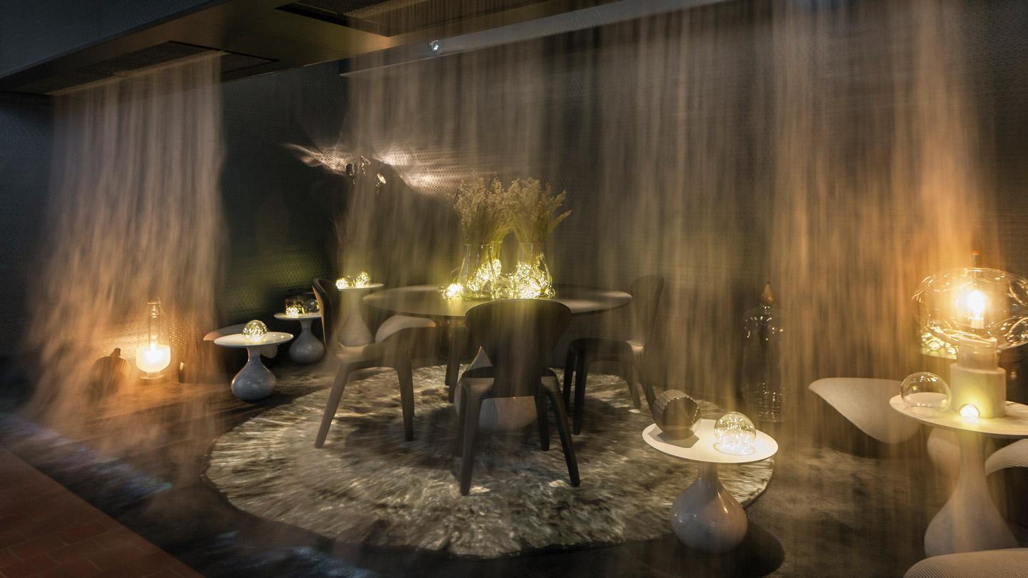 Projections against a wall of mist set the mood in a dining space created by LAB and Roche Bobois.