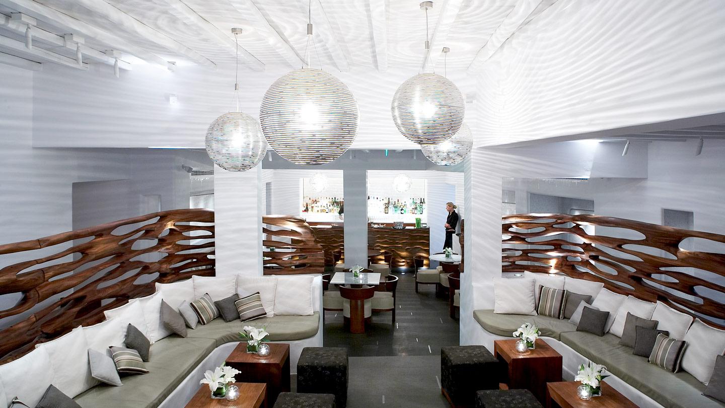 lounge with globe lighting at belvedere hotel in mykonos greece designed by rockwell group