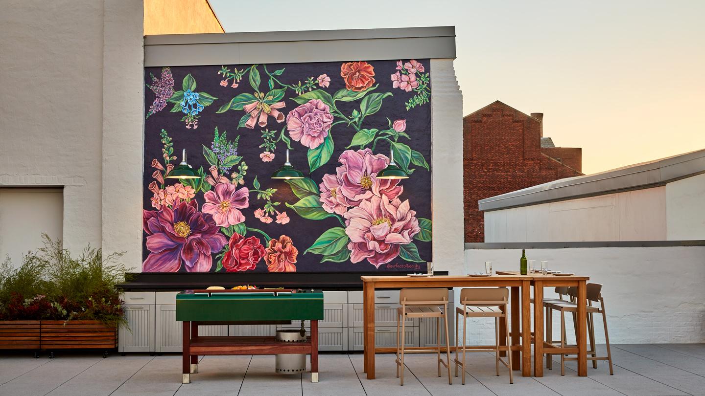 outdoor kitchen and mural at city harvest rooftop terrace, cohen community food rescue center