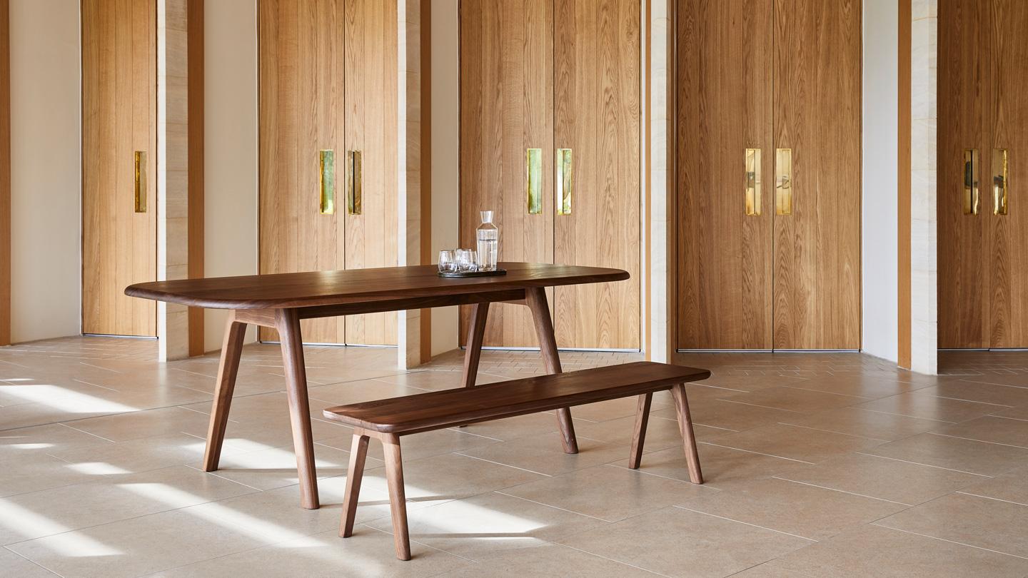 Tables feature the collection's signature rounded forms for tactility and comfort.