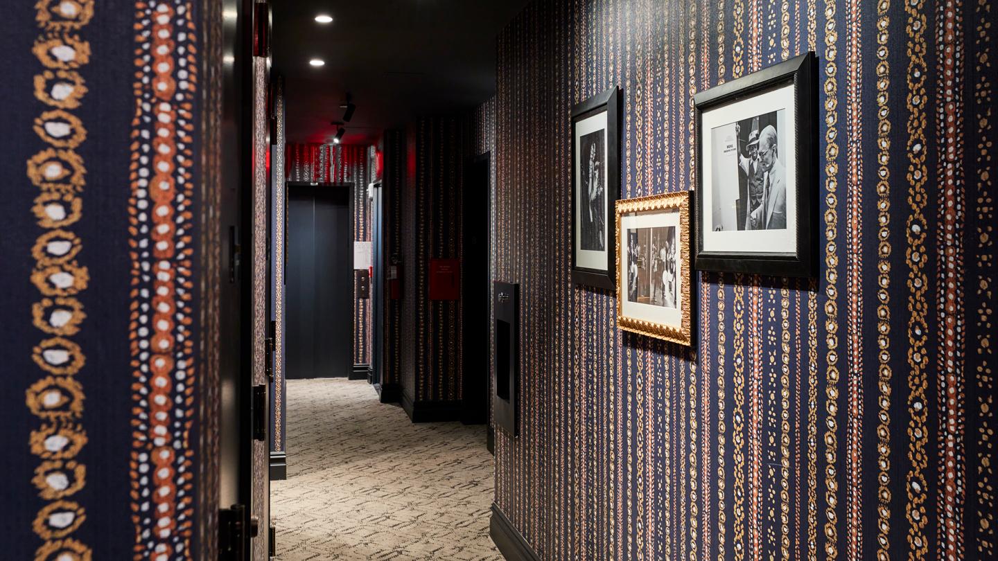In the guest corridors, custom wallcoverings feature abstractions of drawings by costume designers.