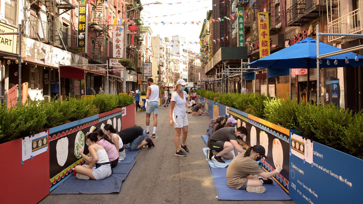 Children painting a mural of dim sum at DineOut Mott Street designed by Rockwell Group