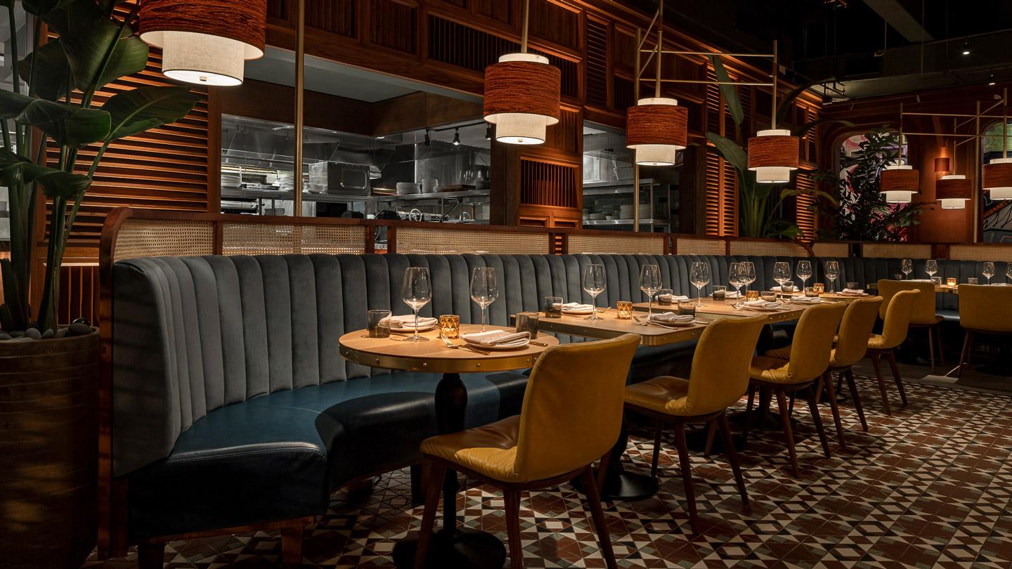Banquettes and dining tables of CHICA Miami's main dining room designed by Rockwell Group